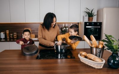 happy-african-american-family-mom-two-sons-having-fun-cooking-lunch-kitchen-high-quality-photo_227201-755